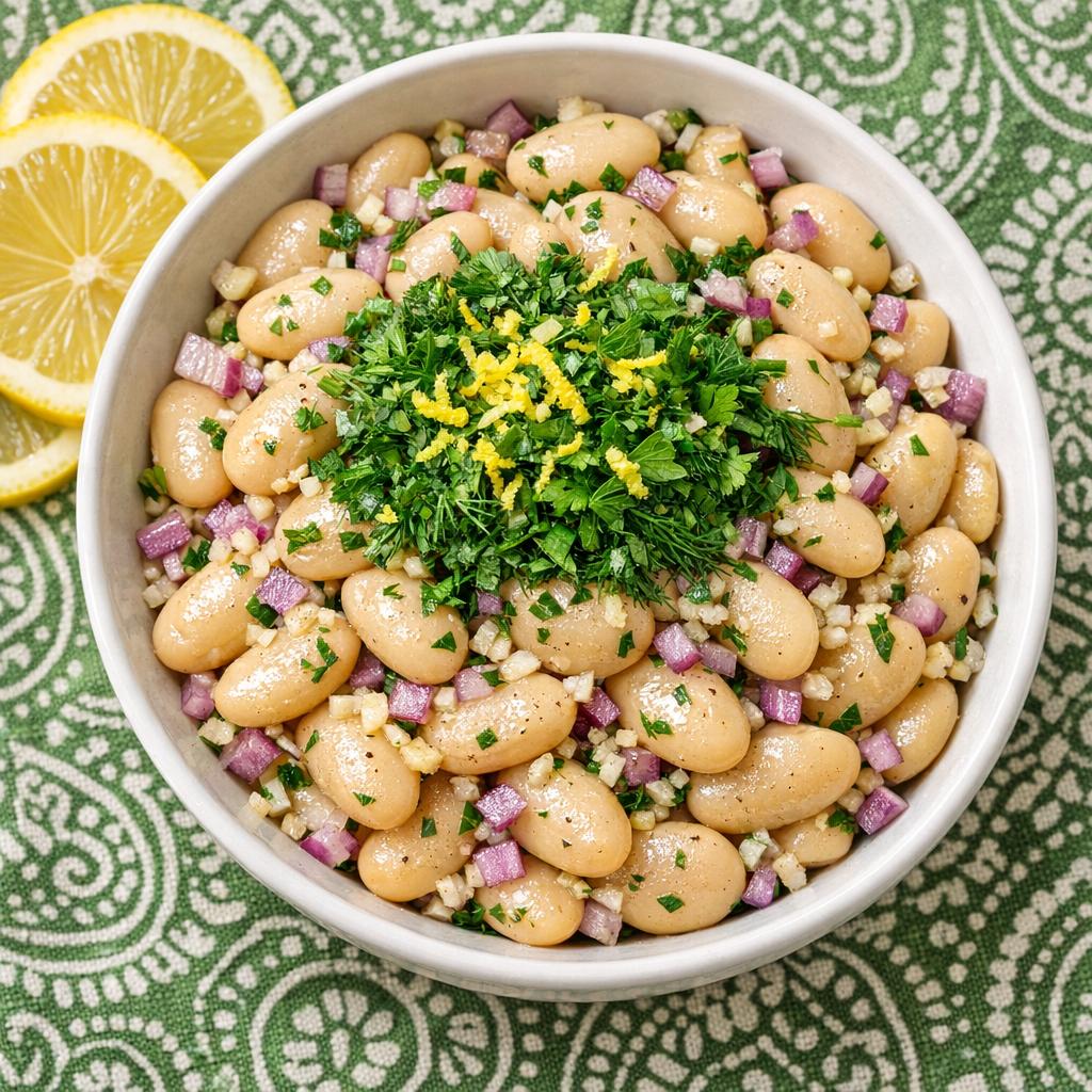 butter bean and lemon herb salad in ceramic bowl on green tablecloth