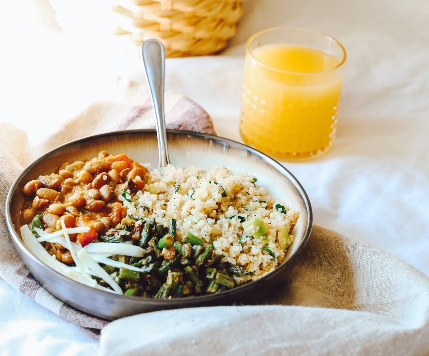 quinoa bowl in glowing morning light with orange juice